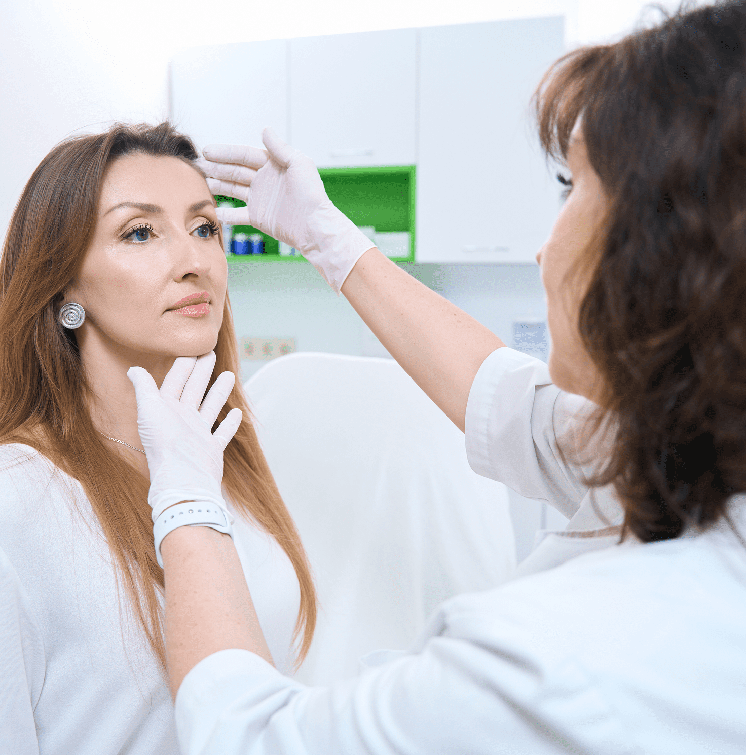 Dermatologist assessing female patient