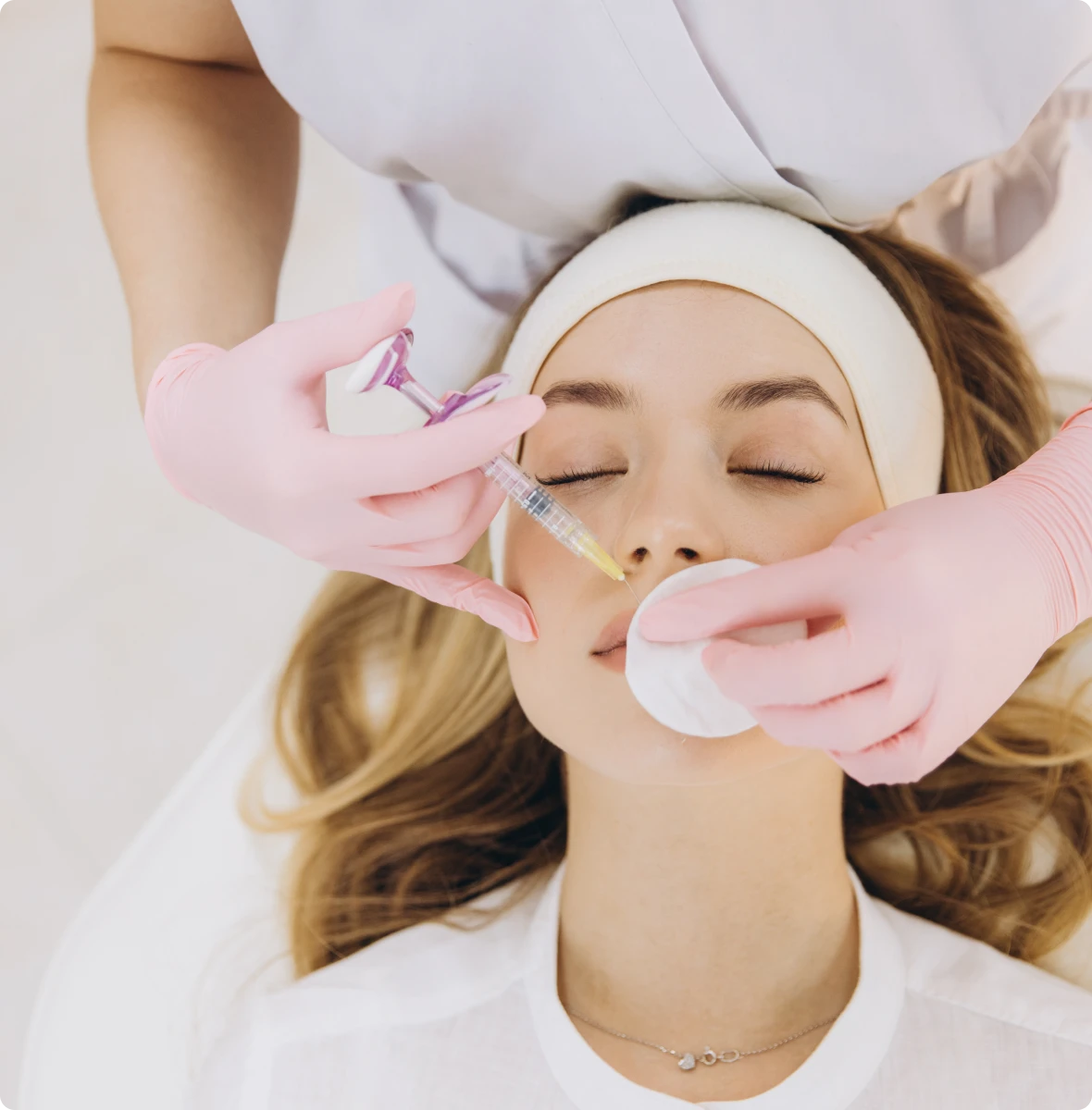 Skincare procedure with syringe and gloves