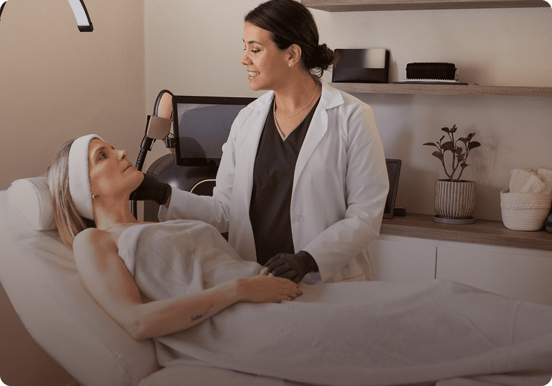 Woman receiving facial treatment at spa