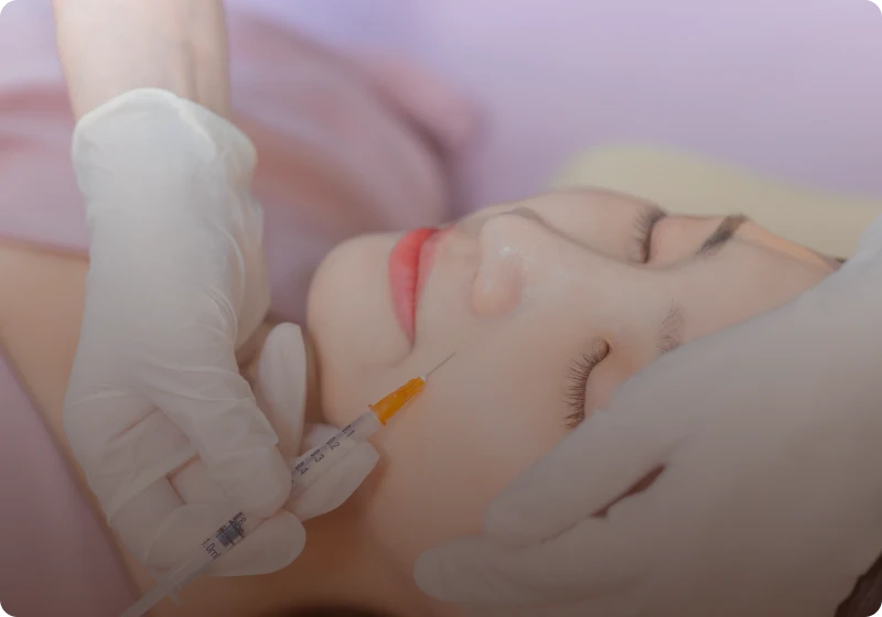 Woman receiving face treatment injection